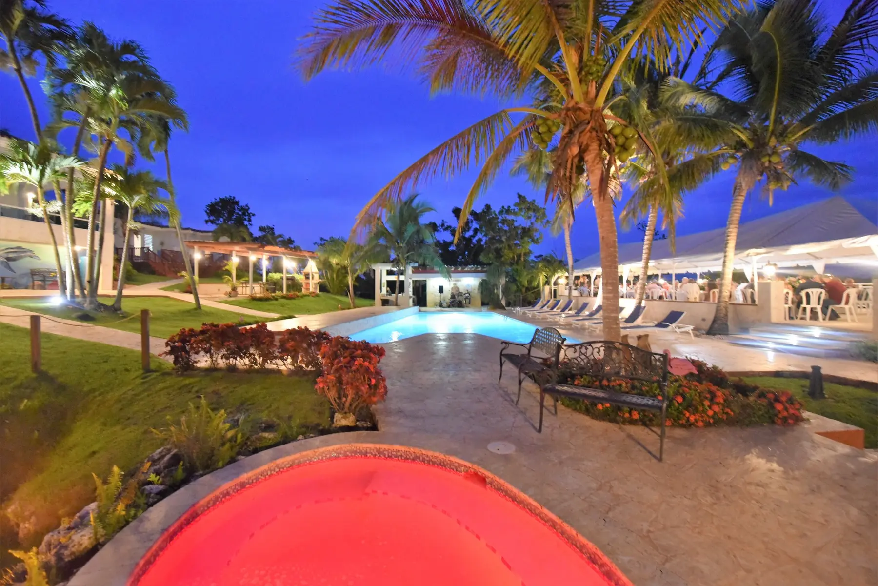 Wedding reception beside the illuminated pool